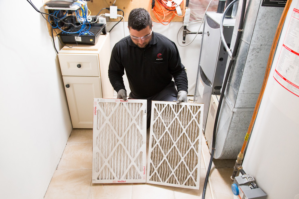 Enercare technician comparing two furnace air filters